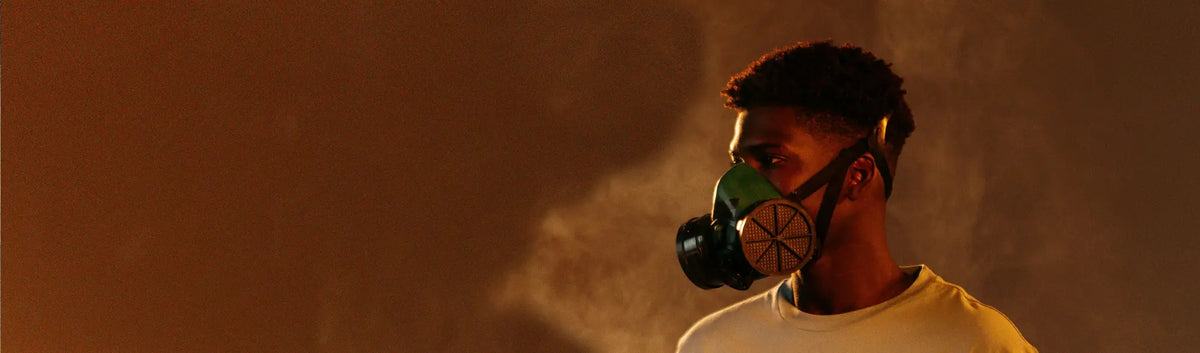 Man in a gas mask wearing high-performance protective disposable respirators