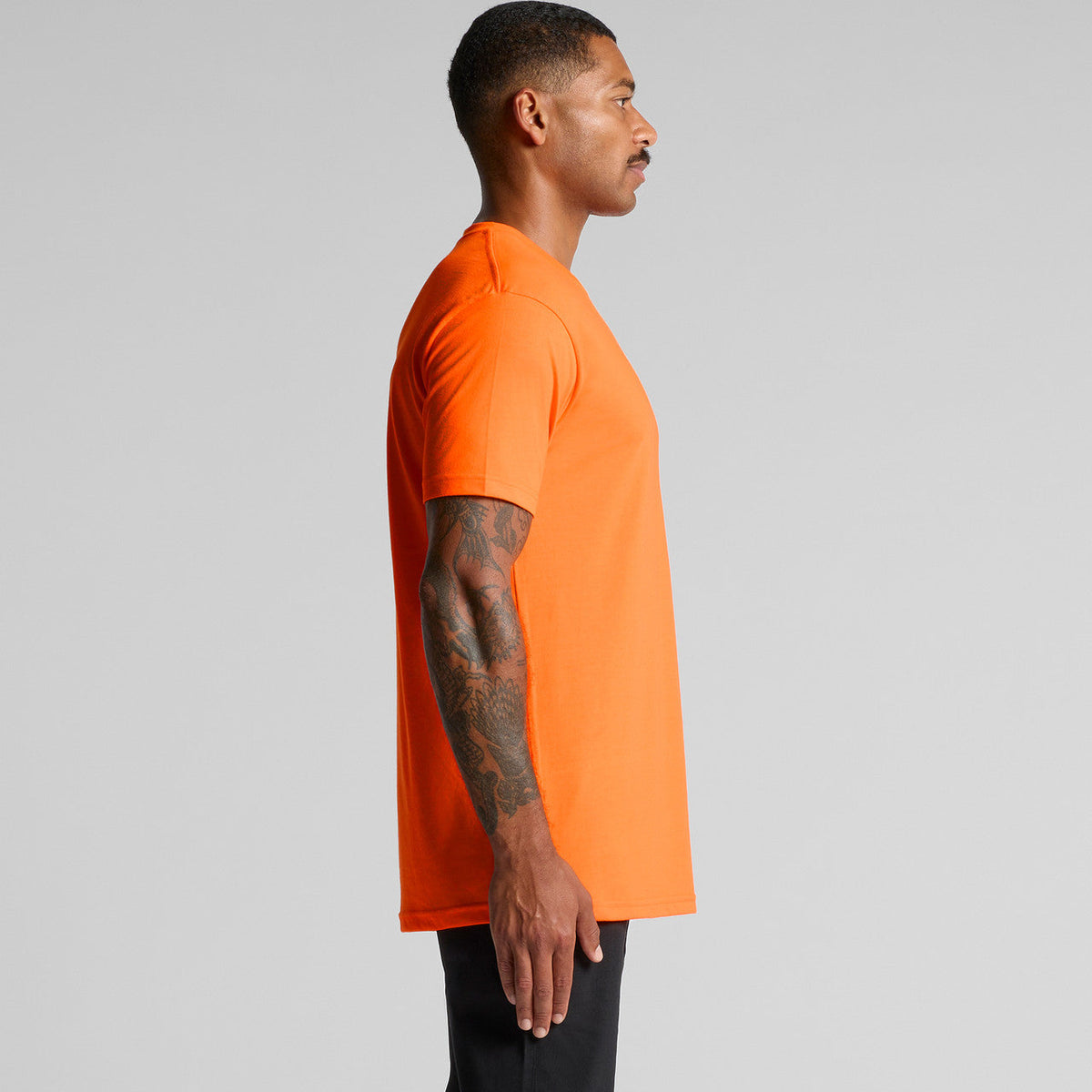 Neon orange t-shirt with short sleeves and ribbed neckline, likely made of cotton or polyester blend.