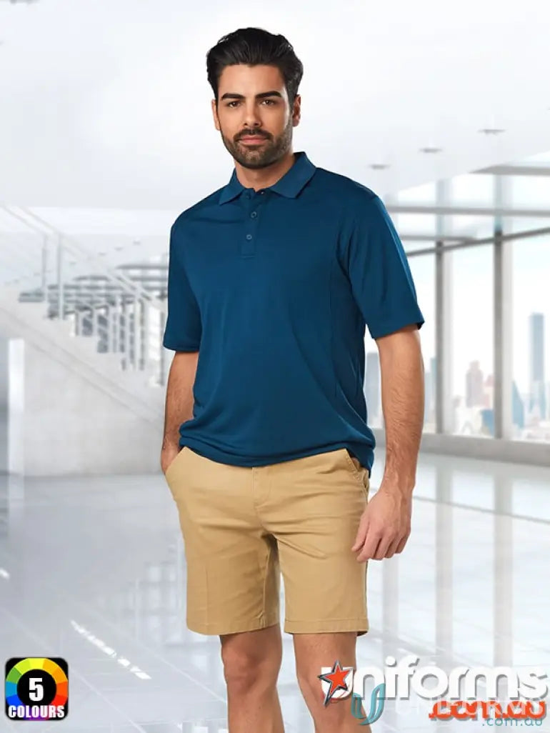 Man in blue polo shirt and khaki shorts wearing IOP Mens Stretch SlimFit Chino Shorts