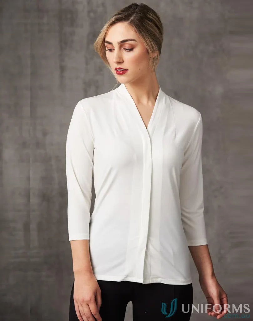 Ladies Isabel Stretch Knit Top worn by woman in white V-neck blouse over black pants