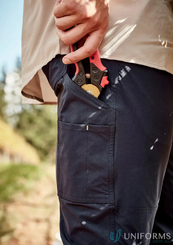 Mens lightweight outdoor pant with large cargo pocket holding gardening shears for outdoor work