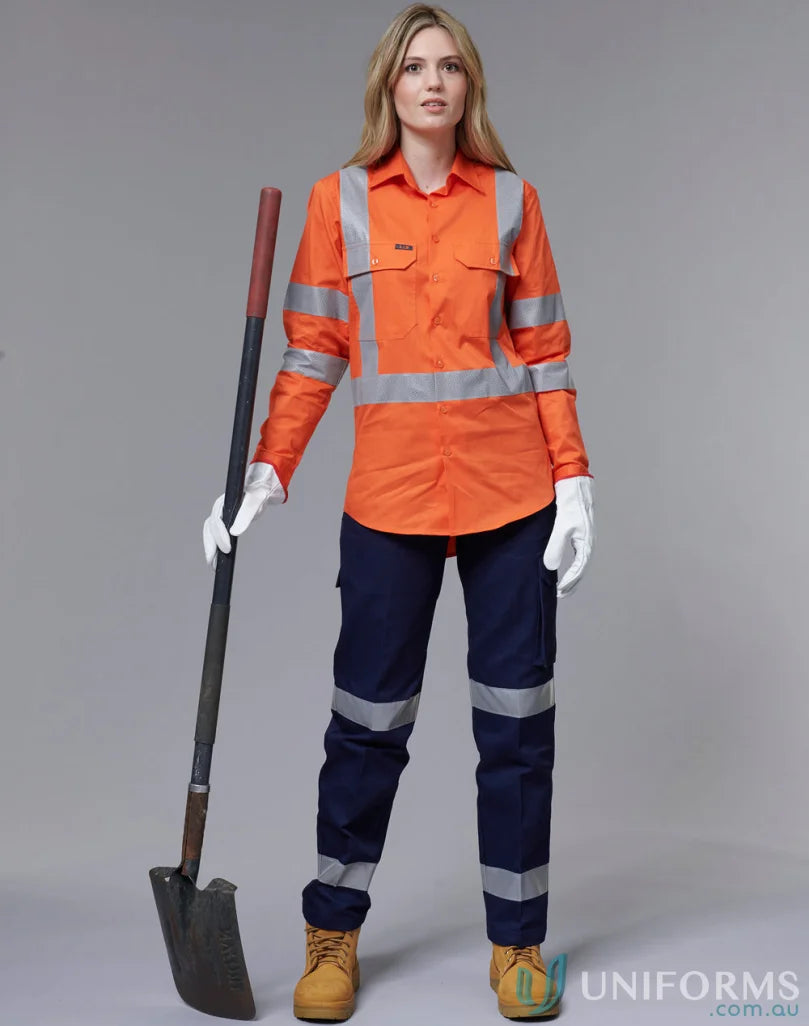 Woman in NSW Rail approved lightweight safety shirt with orange workwear and shovel
