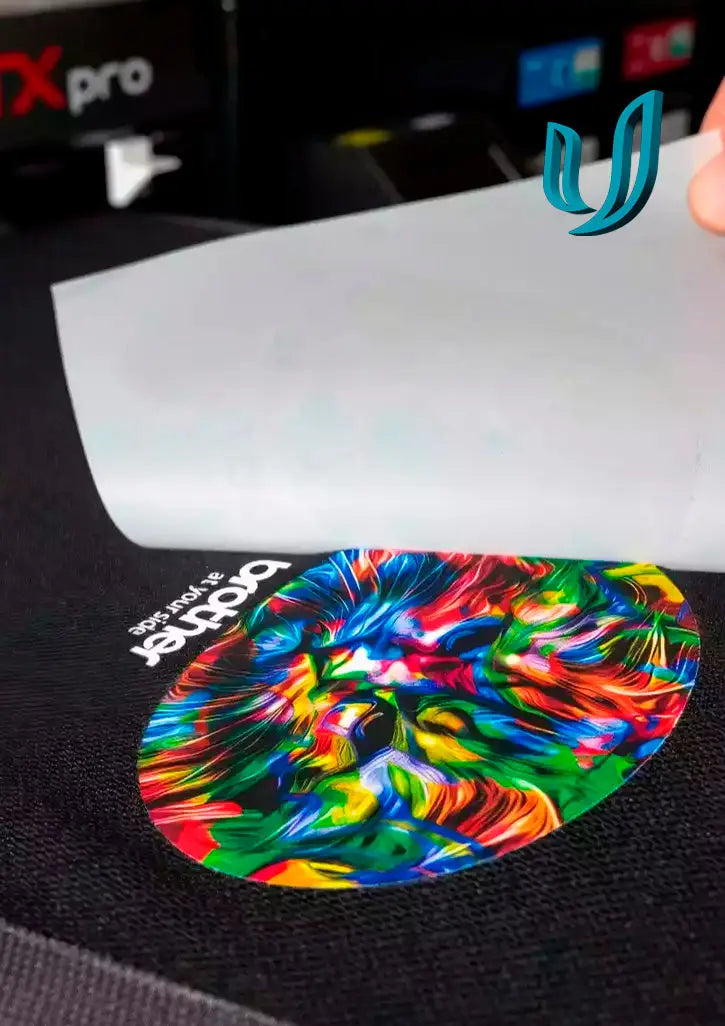 Colorful oval transfer printing design being peeled off, perfect for custom workwear in Australia