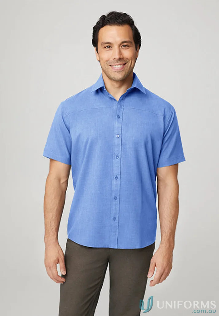 Smiling man in blue short sleeve shirt, perfect for casual wear or sports uniforms