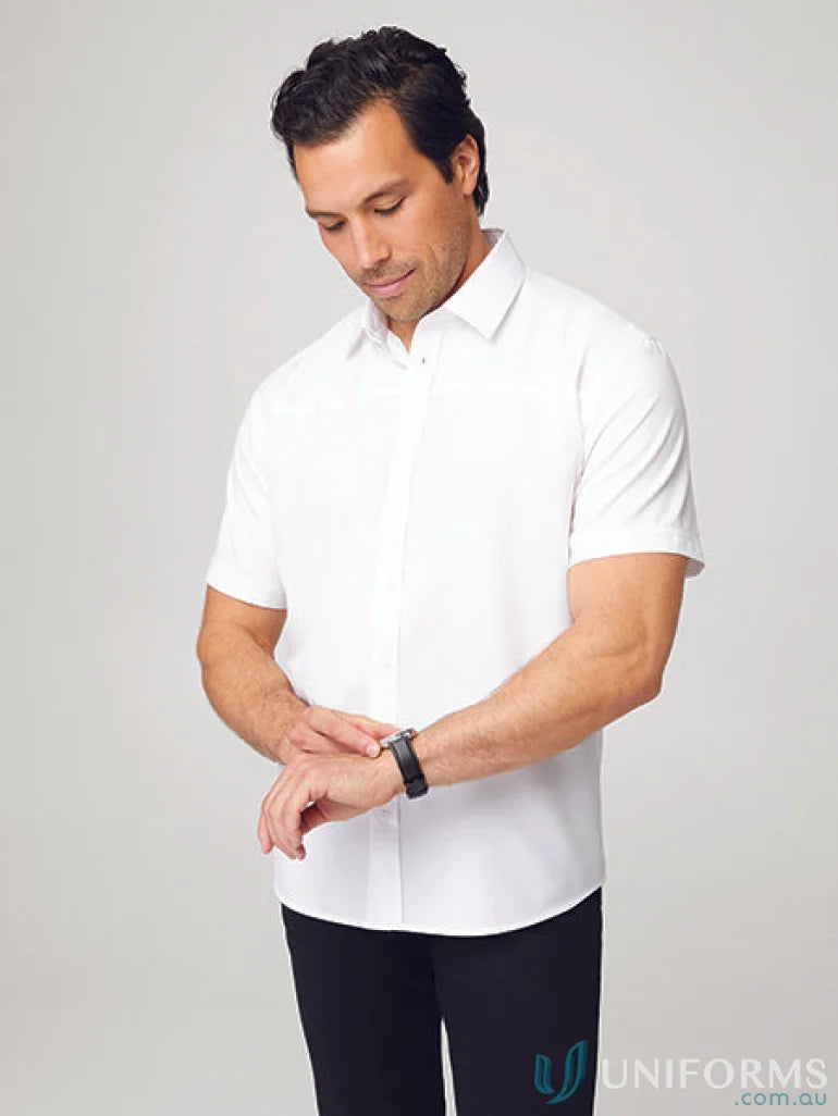 Man in Mens Ezylin Short Sleeve Shirt checking watch, perfect for casual or sports uniforms