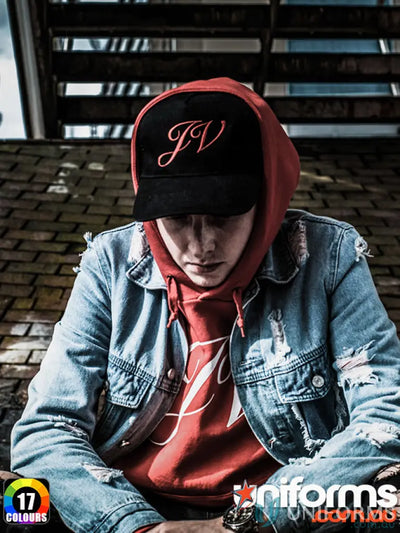 Man in denim jacket and hoodie showcasing MOQ50 Embroidered Caps made of heavy brushed cotton