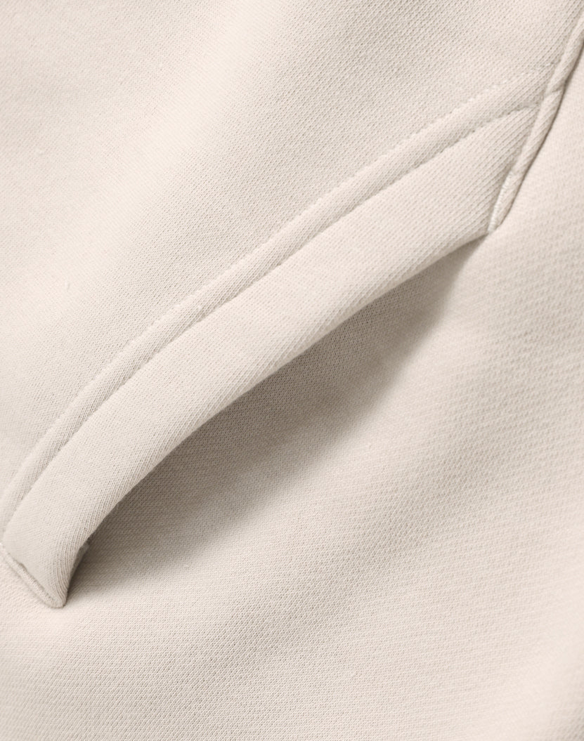 Cream-colored premium oversized bone hoodie with soft textured fabric and neat seams perfect for work uniforms and workwear
