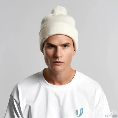 Light-colored recycled acrylic pom pom beanie with a cozy pom pom on top