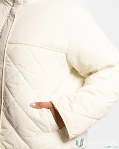 Cream puffer jacket with quilted design and zipper closure.
