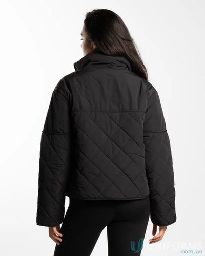 Black quilted puffer jacket with hood and zipper closure.