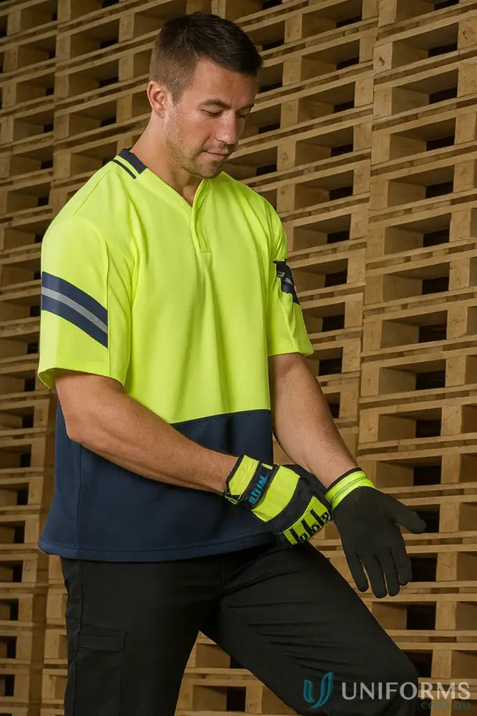Man wearing Syzmik Mens Astro Short Sleeve Polo with reflective stripes and work gloves