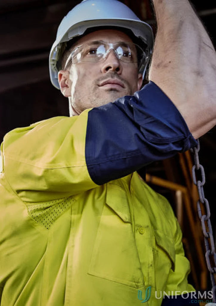 Construction worker in safety gear wearing Syzmik Mens Rugged Cooling Vis Shirt ZW128 focusing on stress points