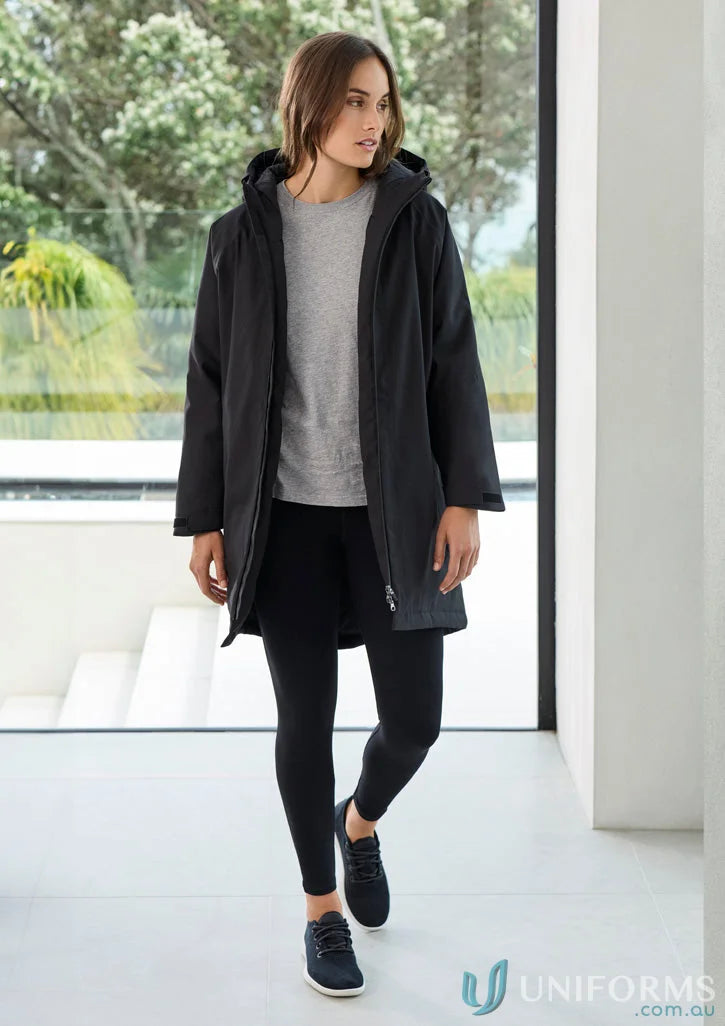 Woman in black hooded Unisex Sphere Jacket with waterproof features and recycled polyester lining