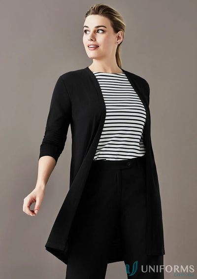 Woman wearing black Chelsea Long Line Cardigan over striped top and black trousers